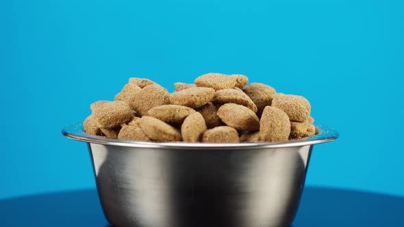 Dried Dog Food in Metal Bowl Closeup Rotating alt