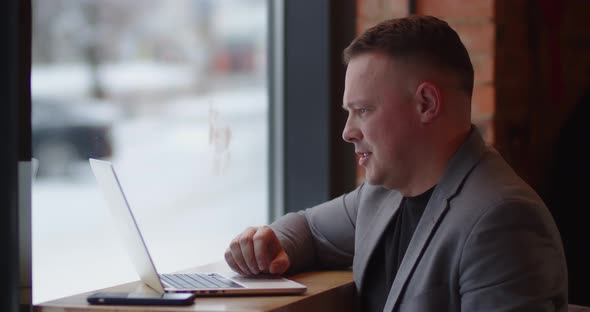 Smiling Man Holding A Conference Via Video Call On Laptop