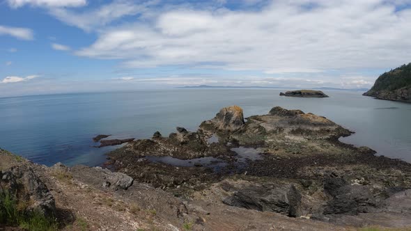 Panning wide shot of Rosario Beach and its numerous tide pools on Fidalgo Island. alt