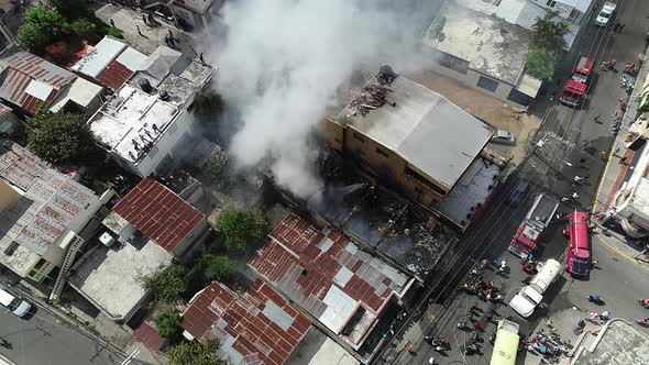 Aerial view of a building fire, a massive smoke cloud rising from the flaming structure, in Brazil - alt