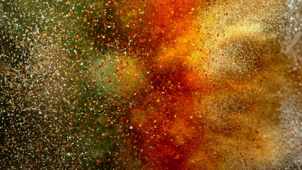 Super Slow Motion Shot of Colorful Seasoning Explosion on Black Background at 1000Fps alt