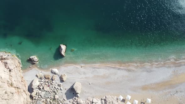 Aerial View From Above on Azure Sea and Pink Pebbles Beach alt