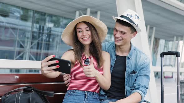 Couple Traveling, Making Photo On Phone Near Airport alt