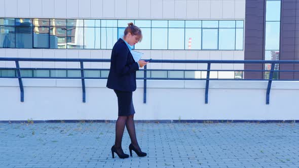 Businesswoman Reads Good News Does Yes Gesture alt