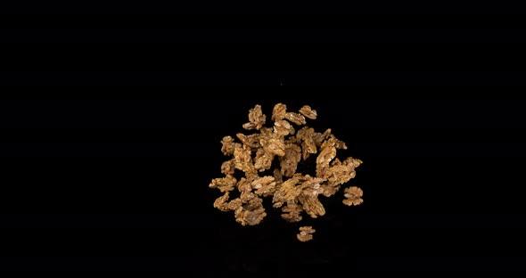 Walnut Kernels, juglans regia, Fruits falling against Black Background, Slow Motion 4K alt