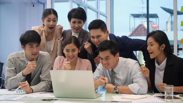 Businessman and businesswoman celebrate for success. alt