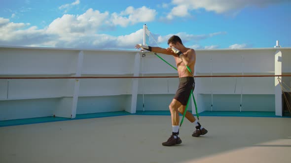 Boxer Exercising Box Workout and Shadow Boxing with Resistance Band Training Strap System