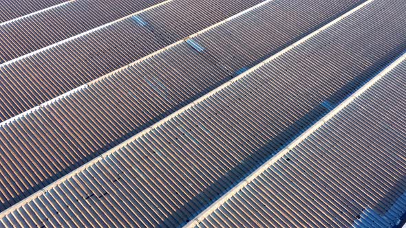 Saw-tooth pattern metal roof of a big factory in a production plant - abstract. Ridges on rooftop alt