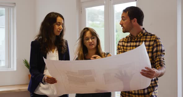 Millennial creative professionals working in a creative office alt