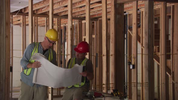 Construction workers looking at plans together