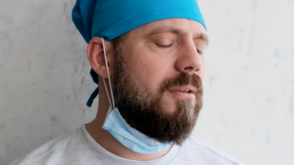 Depressed Doctor After a Difficult Operation Removes the Mask and Starts To Smoke alt