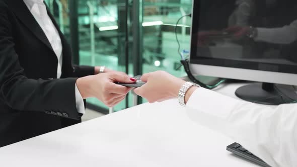 check-in onboard aircraft, close-up, Checking passports at the airport check-in. alt