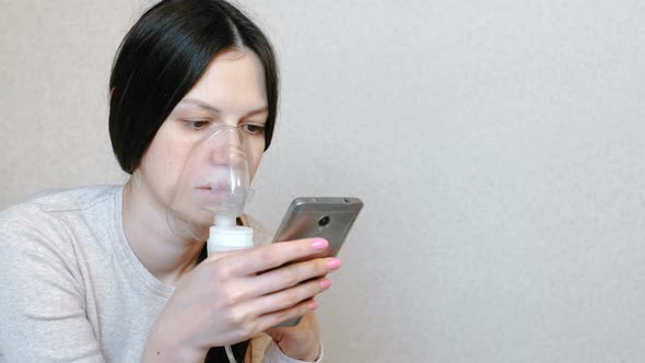 Use Nebulizer and Inhaler for the Treatment. Young Woman Inhaling Through Inhaler Mask