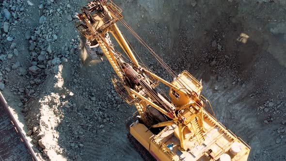 Excavator quarry loading train iron ore industry mining. Mining industry concept. alt