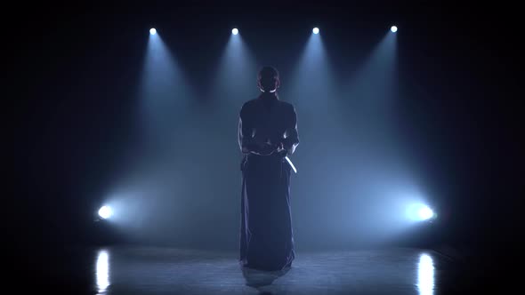 Aikido Master Technique Demonstration with Japanese Sword Katana. Silhouette on Black Studio alt