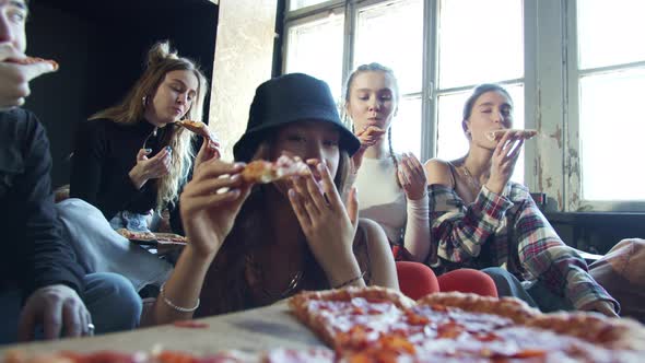Closeup Video of Modern Hipsters Eating Pizza in a Dance Studio alt