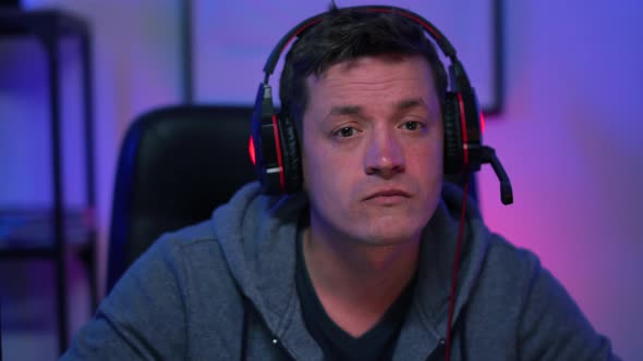 Gamer Guy Actively Playing Arcade Game on Desktop Computer Wins Loses alt