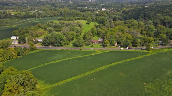 Aerial View of a American Countryside Village House Has a Large Garden with of Farm Fields in alt