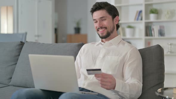 Businessman Making Online Payment on Laptop at Home alt