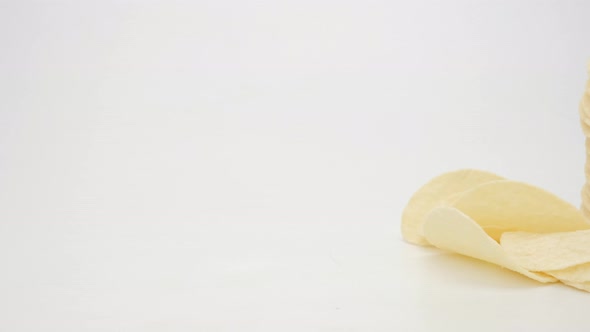 Dolly shot potato chips on white background, Close up.