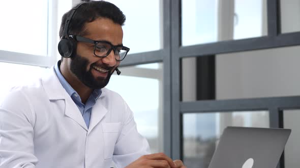 Indian Doctor Giving Consultation to a Client Online Working Remotely During Pandemic alt