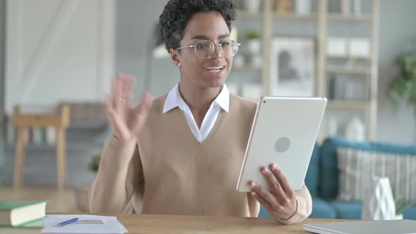 Cheerful African Girl Doing Video Chat on Tablet alt