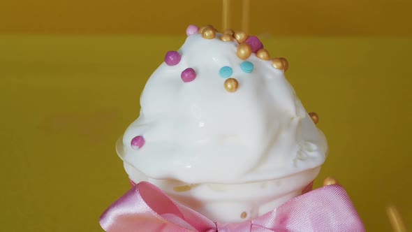Ice Cream Is Decorated with Sprinkles. Decoration of Ice Cream in a Pastry Shop. Close-up.