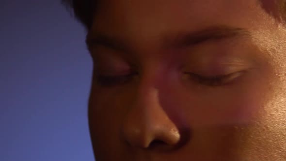 Close Up of Young Man Closed Eyes with Projector Reflection