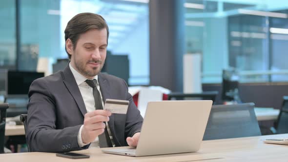 Businessman Making Successful Online Payment on Laptop alt