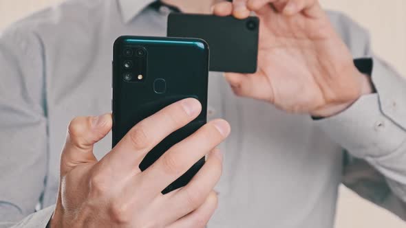 Young Man Uses Smartphone to Scan QR Code on Cold Crypto Wallet for Transaction alt