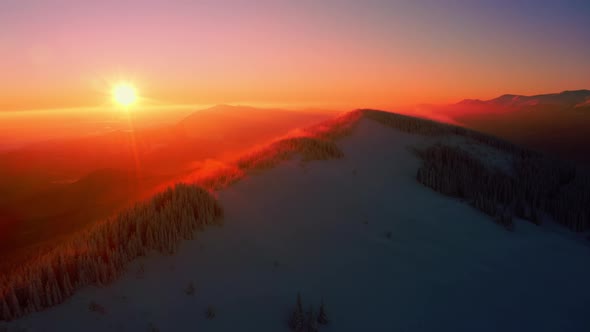 Aerial view of Snowy Mountain Range Silhouette Sunrise Aerial View alt