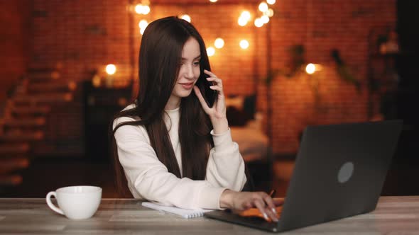 A Woman is Sitting in Her Home Office alt