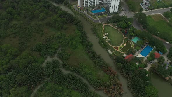 drone shot flying over wetlands to a modern high rise development on the outskirts of Ho Chi Minh Ci alt