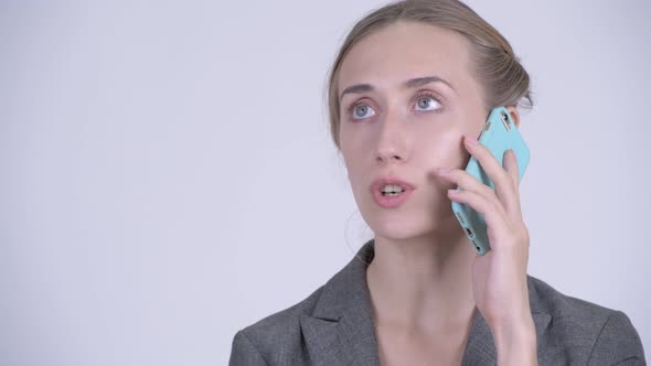 Face of Happy Young Blonde Businesswoman Talking on the Phone alt