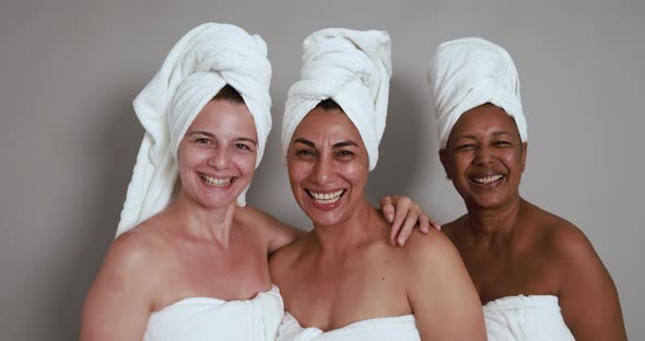 Multiracial senior women enjoy beauty treatment day together alt
