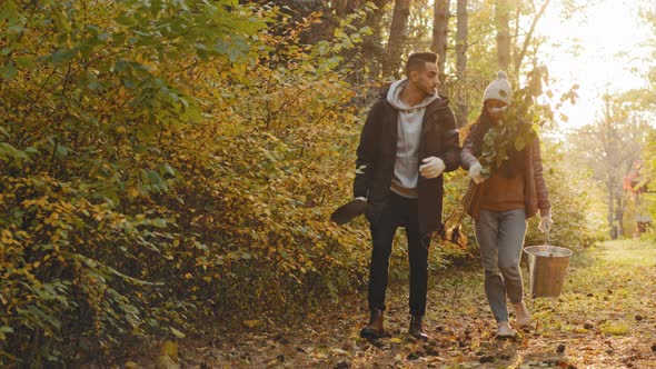Young Couple in Love Happy People Walking in Autumn Park Talking at Sunset Enjoying Nature alt