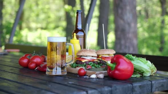 Cheeseburgers Served with French Fries on a Board Outdoors alt