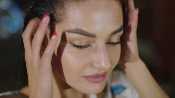 Close Portrait of Passionate Brunette Lightly Flirting with Wet Hair at Camera alt