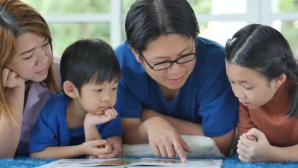 Happy Asian Family Reading Book At Home alt