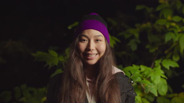 Lovely Asian Female Traveler Smiling in Nature alt