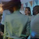 Happy Young Lady Dancing with Colleagues at Corporate Party Holding Glass of Champagne in Office at - VideoHive Item for Sale