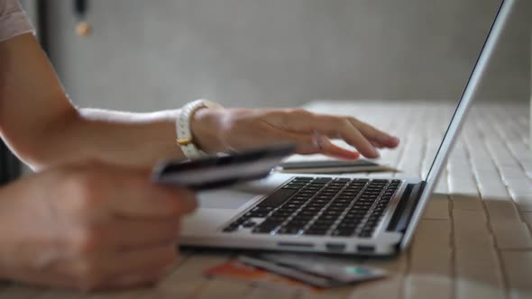 Close Up Of Woman Shopping Online Using Laptop With Credit Card alt