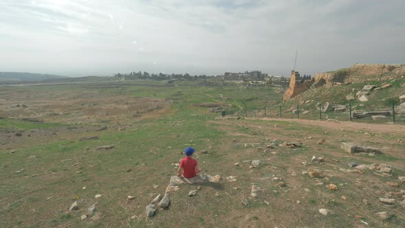 Child Looking at Ruins of Ancient City Hierapolis in Pamukkale, Turkey alt