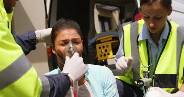 Patient receiving oxygen mask from ambulance team alt
