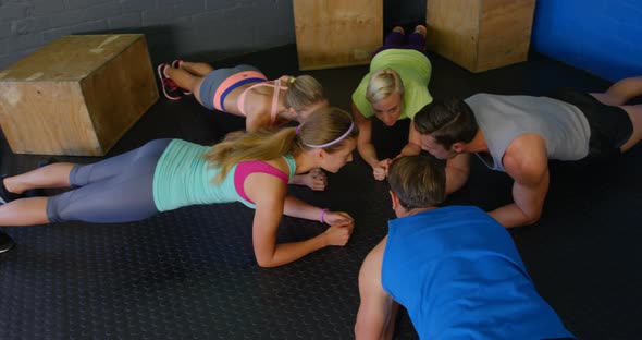 Group of people performing fitness exercise alt
