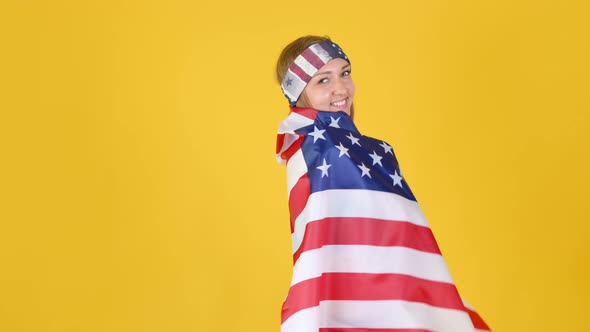 Girl Wearing Sportswear and Headband Waving and Wrapping in the American Flag.