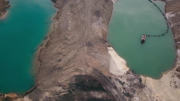 Aerial view of a sand quarry full with green water