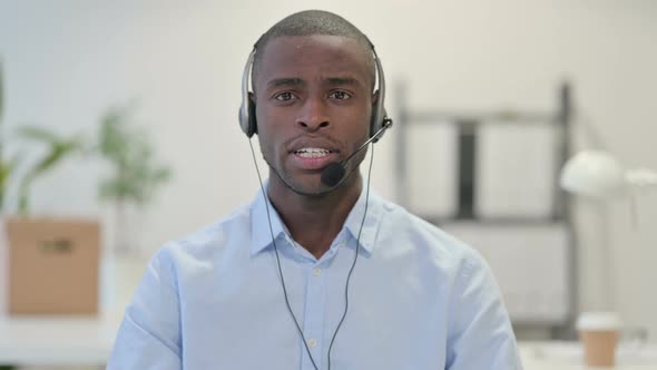 Portrait African Man Talking Through Headset Call Center alt