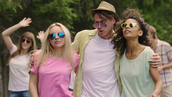 Handsome Man Flirting With Two Beautiful Multiethnic Girls, Having Fun at Party alt