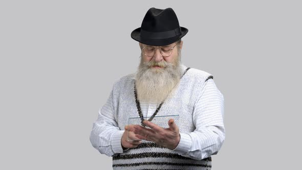 Old Bearded Man Scrolling and Swiping Glass Transparent Copyspace Tablet alt